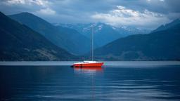 A Red Boat on Body of Water Near Mountains[1920x1080]